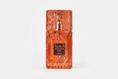 Lattafa Khamrah Mira amber orange textured perfume bottle on a white background.